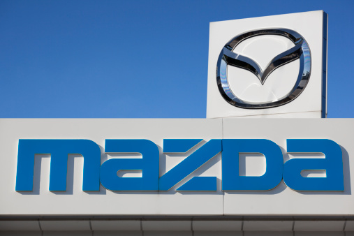 Antalya, Turkey - October 28th, 2011: The roadside blue sign of Mazda Motor Corporation brand name and local dealership building. Japanese automotive manufacturer founded in 1920 in Hiroshima, japan. The company formally adopted the Mazda name in 1984, though every automobile sold from the beginning bore that name. Mazda have a close partnership with Ford Motors since 1979.