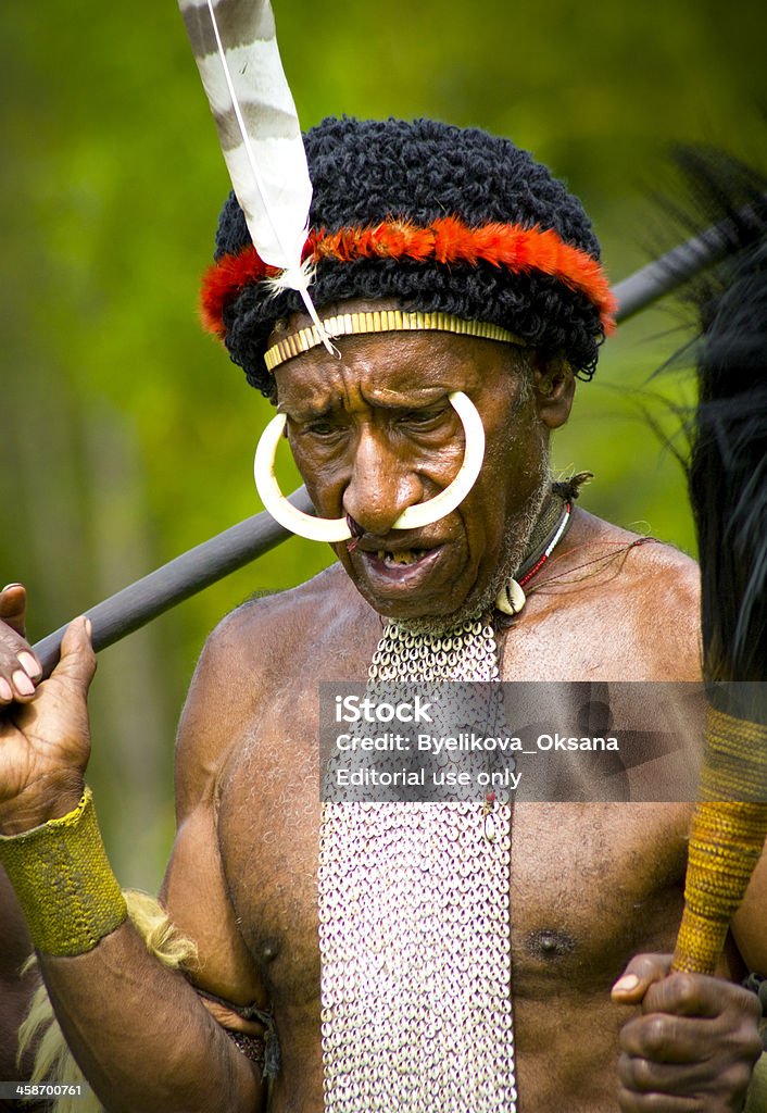 Tribal Face "NEW GUINEA, INDONESIA - December 28, 2010: An unidentified warrior of a Papuan tribe in traditional clothes and coloring in New Guinea Island, Indonesia on December 28, 2010" Adult Stock Photo