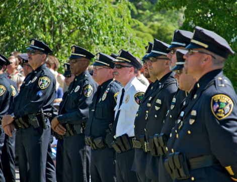 New Canaan, Connecticut, USA -  May 31, 2010: New Canaan Police Department officer stand in formation  at Memorial Day Ceremonies in Lakeview Cemetery, New Canaan, Connecticut, USA.
