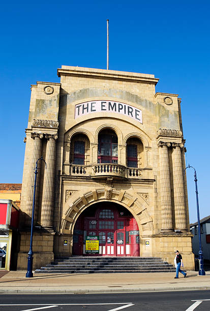 Former Empire Theatre on Great Yarmouth promenade Great Yarmouth, England - September 28, 2011: A man walking past the old Empire Theatre on Marine Parade, Great Yarmouth, a typically English seaside resort on the east coast of England. The Empire was built in 1908 and over the intervening century has been used for theatrical productions and films. It closed in 2008. 1908 stock pictures, royalty-free photos & images