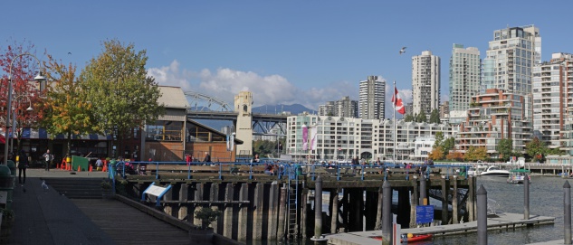 Vancouver, Canada - October 13th, 2011: Granville Island with a view of False Creek on an autumn afternoon. The Market Courtyard is a hub for local residents and visitors.