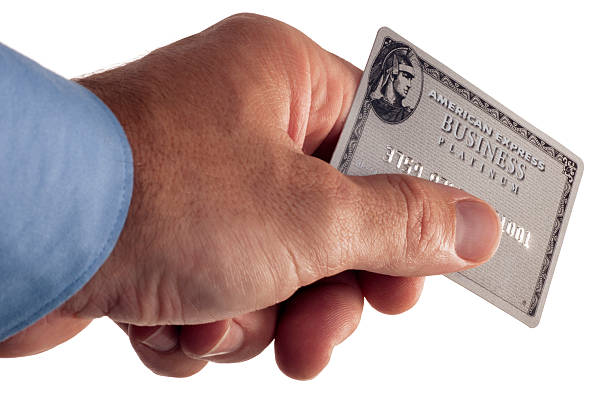 American Express Credit Card San Diego, California, USA - April 21st 2011: This is a photo isolated on a white background of a man holding out a fake American Express Credit Card. American Express credit cards are accountable for 24 percent of credit card transactions in America. american express stock pictures, royalty-free photos & images