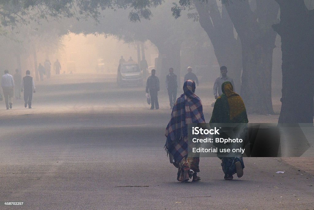 New Delhi street life "New Delhi, India - November 12, 2012.  Daily street life in the early morning during extreme smog conditions.  New Delhi air quality has plummeted over the last few years and is now considered some of the worst in the entire planet." Air Pollution Stock Photo