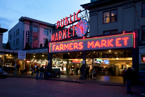 Seattle, WA, United States - November 5, 2011: Pike Place Market in Seattle at Dusk - Famous landmark in Seattle, Neon Lights Illuminate Pike Place Market before closing.