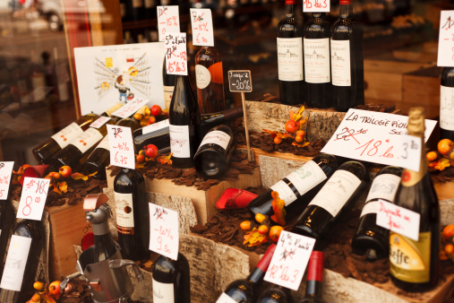 Paris, France - September 24, 2011: A shop window with a wide selection of wine bottles seen from the street in a wine store located in Montmartre district in Paris. France has the world's second largest total vineyard area and it is one of the largest wine producers in the world.