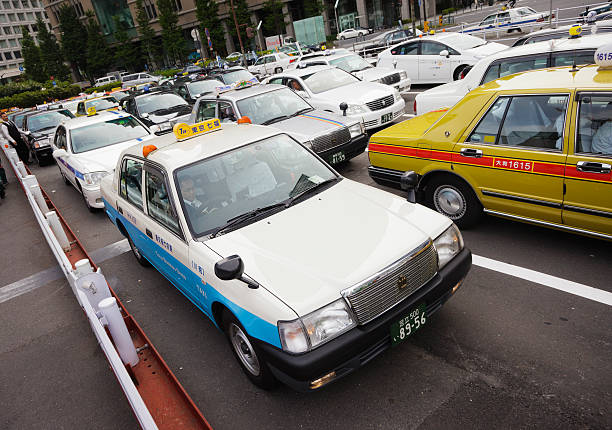 Japanese taxi and city light in the background at night, Tokyo, Japan
