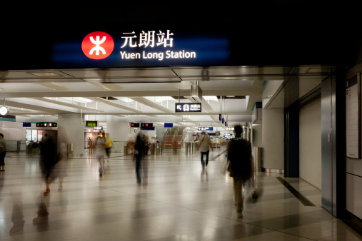 Hong Kong, China - August 13, 2011: People walk past the concourse at Yuen Long Station. This Mass Transit Rail (MTR) station is located in Yuen Long Town, New Territories, Hong Kong. Yuen Long Station providing the services for West Rail Line.