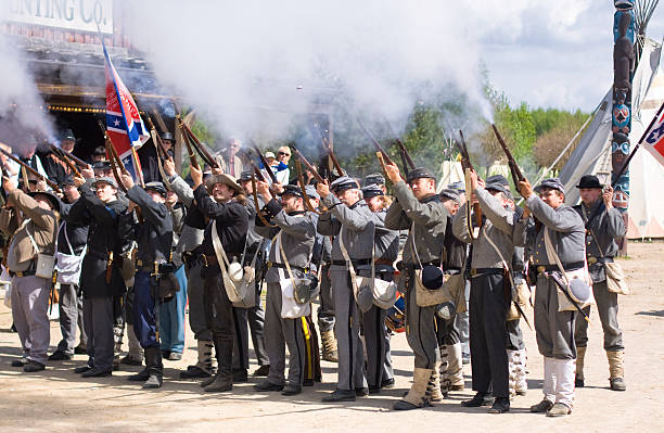 American Civil War: southern shooting formation Templin, Germany - May 01, 2010: Civil War  Reenactment: Confederate soldiers firing at Union troops firing squad stock pictures, royalty-free photos & images