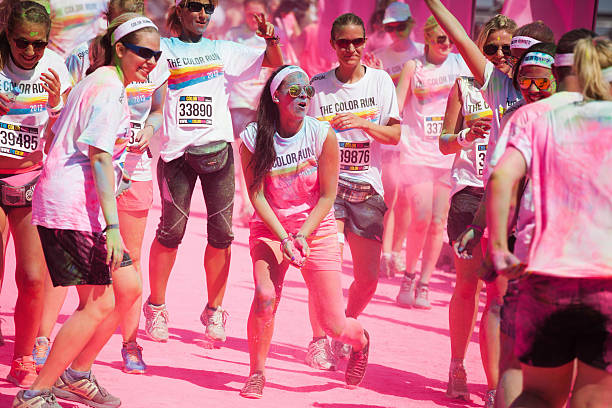 funny Color Run in Cologne "Cologne, Germany - July 21, 2013: competitors at a ColorRun in Cologne, Germany. Color Run is since a few years a world wide upcoming charity event with fun character. The competitors are sprayed with color powder." cologne germany stock pictures, royalty-free photos & images