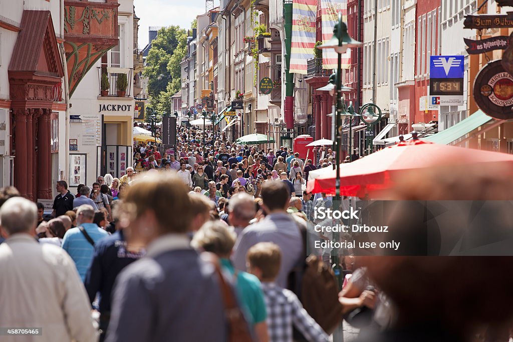 Heidelberg, Germany Heidelberg, Germany - June 11, 2011: Large crowd of tourists walking in the central city zone, down the Hauptstrasse street;Heidelberg is situated on the Neckar river, in the German state of Baden-Wurtemberg and is a tourist destination with over 3 million visitors every year Heidelberg - Germany Stock Photo