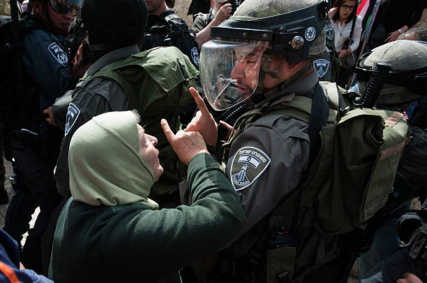 Palestinian woman confronts Israeli soldier stock photo