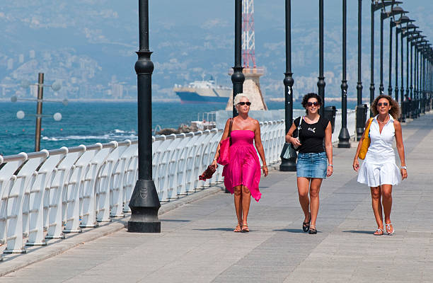 Beirut, Lebanon - August 26, 2010: Three middle-aged ladies walk down the Beirut Corniche near midday. The Corniche is a popular spot in the city during the summer, especially later in the day when it is cooler.