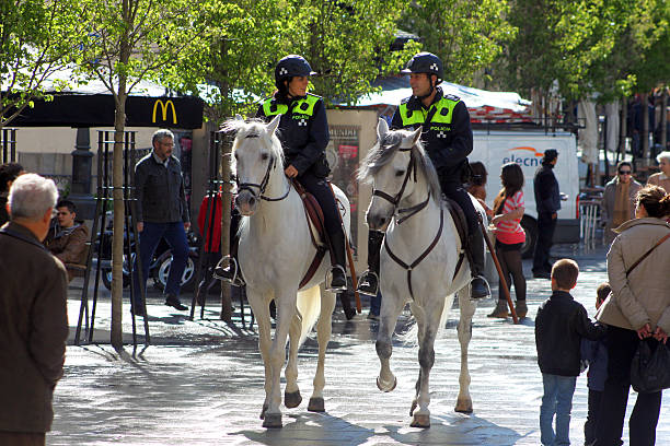 Madrid horse police "Madrid, Spain - April 30, 2012: Madrid horse police units patroling through downtown" police policewoman women spain stock pictures, royalty-free photos & images