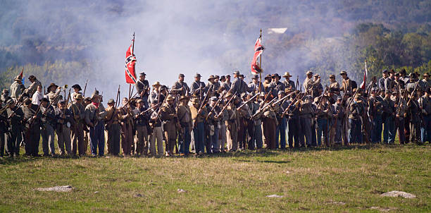 US Civil War Confederate Infantry in Shenandoah Valley Middletown, USA - October 16, 2005: Civil War reenactors play the parts of Confederate infantry on the Cedar Creek Battlefield at the northern end of the Shenandoah Valley of Virginia. Southern troops mass on the crest of a hill prior to an attack. This is during a reenactment of the October 19, 1864 Battle of Cedar Creek which ended in a Union victory and eliminated significant Confederate presence in the valley. battle reenactment stock pictures, royalty-free photos & images