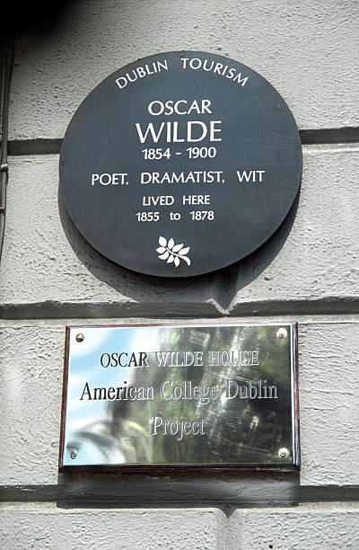 Oscar Wilde lived here Dublin, Ireland - June 16th 2005: Plaque in the georgian house where lived Oscar Wilde, in Merrion Square. The American College Dublin came into possession of this house in 1994. oscar wilde stock pictures, royalty-free photos & images