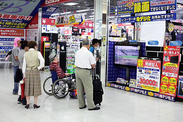 People watching baseball on TV in electronic store stock photo