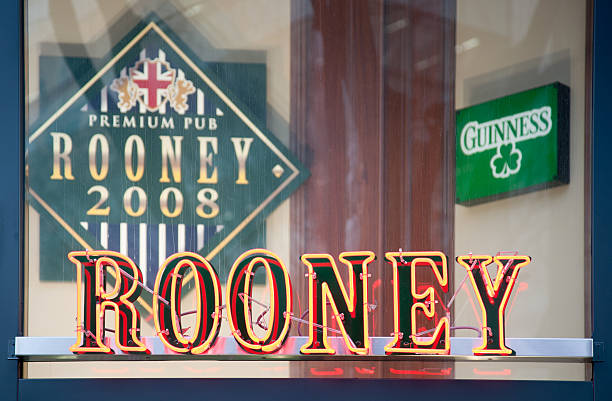 Rooney bar, Shibuya Tokyo, Japan Shibuya, Tokyo, Japan - February 26, 2011.Rooney neon sign outside the Rooney Pub with \"Premium Pub Rooney 2008\" sign and green \"Guiness\" sign through window in background. wayne rooney stock pictures, royalty-free photos & images
