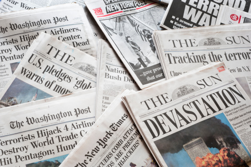 Pile of old newspapers magazines on toned blur background