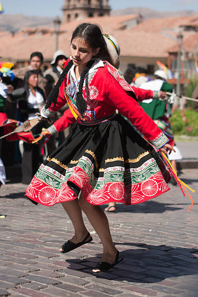 Young Woman Dancing during Cusco Parade Cusco, Peru - June 19, 2010: A young woman wearing an elaborate Peruvian costume performs a Peruvian dance during the day time parades which are part of the week long festivities of the Inti Raymi Festival. The parades are held in Plaza de Armas, Cuscos' main square. inti raymi stock pictures, royalty-free photos & images