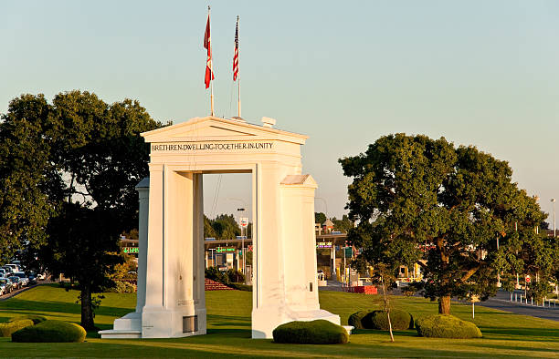 Peace Arch at Sunset Blaine, Washington, USA - July 11, 2012: The Peace Arch on the USA/Canada Border was built to dedicate 100 years of peace between the United States and Canada. The project was commissioned in the early 20th century by the wealthy railroad executive and entrepreneur Sam Hill who was also a Quaker pacifist. The Peace Arch, built in 1921, is located between Douglas, British Columbia, Canada and Blaine, Washington State, USA. jeff goulden border security stock pictures, royalty-free photos & images