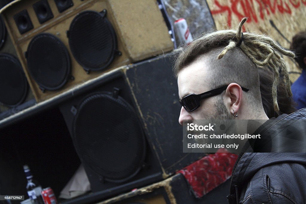 Punk in sunglasses, Notting Hill Carnival "London, England - August 29, 2011: A punk man calmly enjoys the roots reggae being blasted from one of the Notting Hill Carnival's sound systems. The carnival, which takes place in west London every August, attracts one million revellers to the city's streets." Adult Stock Photo