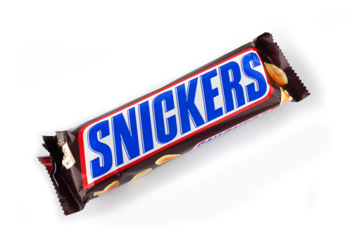 Kampen, The Netherlands - July 7, 2011: Unwrapped Snickers chocolate and peanut candybar isolated on a white background.