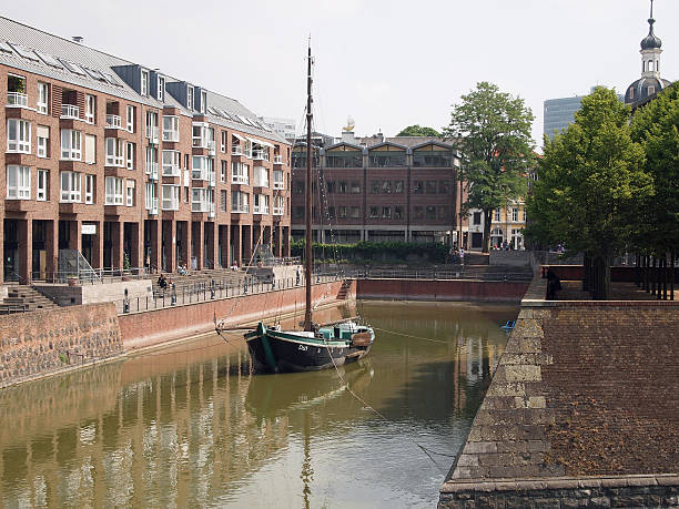 Dusseldorf, Germany - May 3, 2013: Boat in harbor in Dusseldorf in Germany. Tourists nearby.