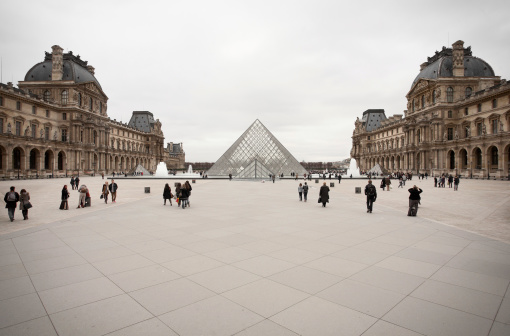 Paris, France - February 26, 2011: View of the Louvre Pyramid in the center of the Napoleon Courtyard of the Palais du Louvre