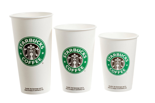 Chico, California, USA - February 28, 2011 : 3 different sizes of Starbucks paper cups, Vente, Grande and tall (Left to Right). Seattle based Starbacks operates a worldwide chain of over 15,000 coffeehouses.