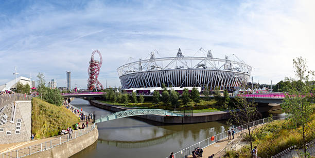 The Orbit and Olympic Stadium London, England - September 6, 2012: The canals of the Olympic Park in Stratford, London. The London 2012 Olympic and Paralympic Games Stadium is in the background along with the Orbit, a viewing platform. Visitors to the park can be seen walking along the canal pathways. water polo photos stock pictures, royalty-free photos & images