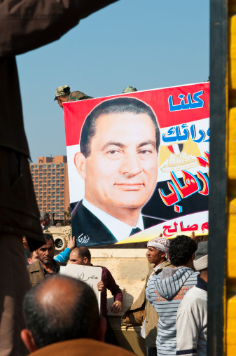 Cairo, Egypt - February 2, 2011:During the demonstrations that rocked Cairo in early 2011, this poster of then-President Mubarak was carried by his supporters in downtown Cairo. Nine days later, however, in the face of continued anti-government demonstrations, Mubarak stepped down from office and brought to an end his thirty-year rule.