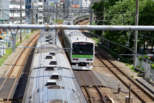 Tokyo, Japan - May 30, 2011 : Yamanote Line train past the Ebisu District in Tokyo, Japan. This train is going to Tokyo Station and Shinagawa Station. Yamanote Line is one of Tokyo\\'s busiest lines.