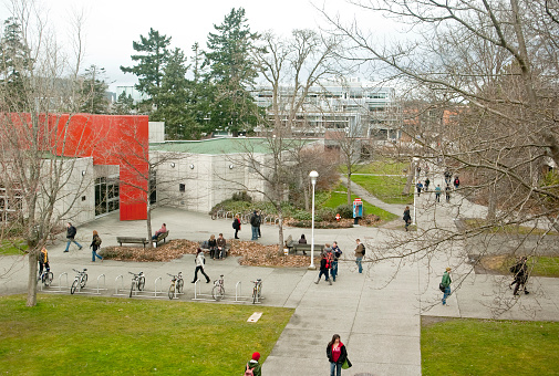 Victoria, Canada - March 10, 2011. Students at the University of Victoria move about between their classes. The Harry Hickman and Social Sciences and Mathematics buildings are prominent.