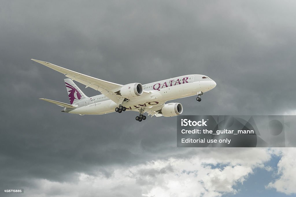 Boeing 787 Dreamliner "Farnborough, UK - July 11, 2012: The newly unveiled Boeing 787 Dreamliner in Qatar Airways livery decending through dark clouds after a flying display at Farnborough International Airshow, UK" 2012 Stock Photo