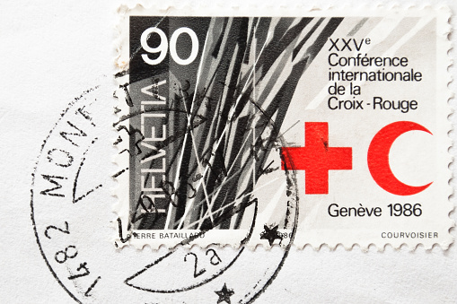 Verona, Italy - February 4, 2012: Croix - Rouge postage stamp. The International Red Cross and Red Crescent Movement is an international humanitarian movement founded by Henry Dunant in  Geneva (Switzerland) in 1863, to protect human life and health, to ensure respect for all human beings, and to prevent and alleviate human suffering, without any discrimination based on nationality, race, sex, religious beliefs, class or political opinions.