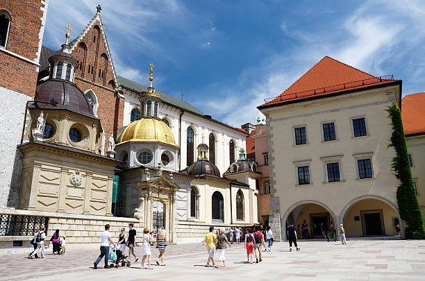 Tourists visiting famous landmark Wawel Royal Castle,Krakow,Poland "Krakow,Poland - June 16,2013:tourists visiting Wawel Royal Castle on Wawel Hill.Krakow is the second largest and one of the oldest cities in Poland." wawel cathedral stock pictures, royalty-free photos & images