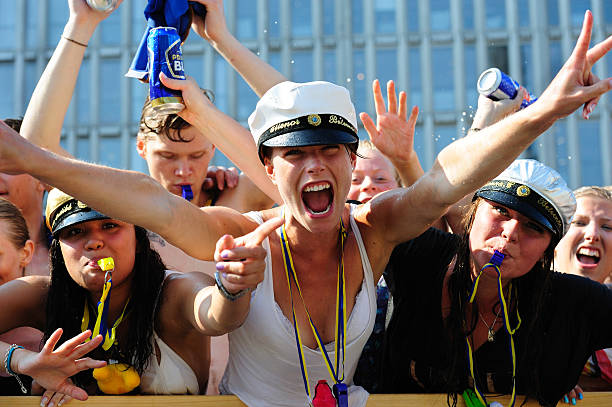 Young Swedish students celebrating graduation Stockholm, Sweden - June, 8 2011: Young Swedish students celebrating graduation. Wearing the traditional hats and visiting the Stockholm city centre, riding an open truck, for a cold bath on a hot summer day in the fountain at Sergels Torg. Picture is shot from the fountain itself. stockholm town square sergels torg sweden stock pictures, royalty-free photos & images