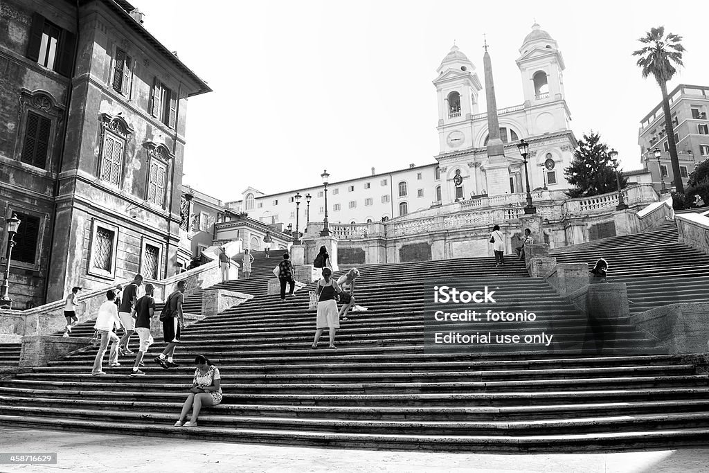 Trinità dei Monti Black and white "Rome, Italy - June 17, 2012: People walking during the morning on the staircase of Trinit&agrave; dei Monti. Photo black and white taken from Piazza di Spagna." Architecture Stock Photo