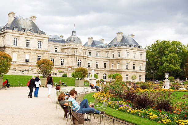 Paris, France - September 06, 2011 : Young people having a break in Luxemburg Gardens (Jardin du Luxembourg) on a cloudy day