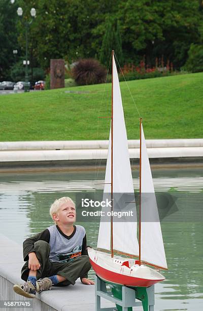 Preteen Boy Looking At The Model Yacht Stock Photo - Download Image Now - Boys, Child, Childhood