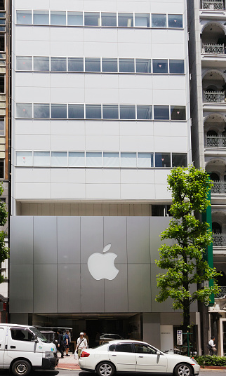 New York City, United States - September 27, 2016: Glass building of the Apple Store with huge Apple Logo at 5th Avenue near Central Park. The store is designed as the exterior glass box above the underground display room