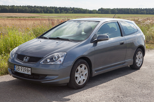 Lubaczow, Poland – July 22, 2013; Gray 2004 Honda Civic (Seventh generation) on a country road.