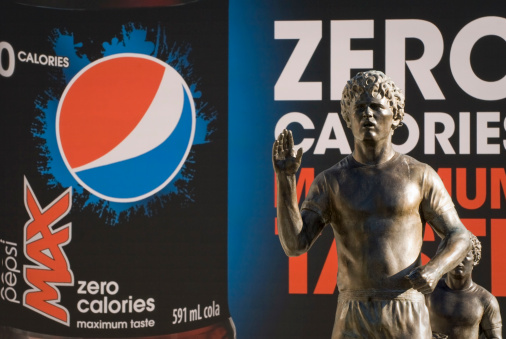 Vancouver, Canada-October 15, 2011: Close-up of Terry Fox statues in front of BC Place stadium with Pepsi advertisement on a huge screen in the background.