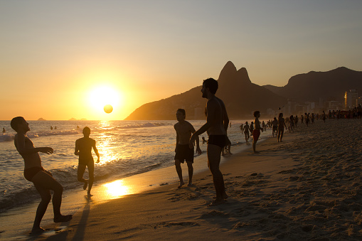Rio de Janeiro, RJ, Brazil - December 19, 2010: Some carioca locals playing altinha (a beach soccer game style) at Posto 9, the most traditional spot at Ipanema beach. People use to clap for the sunset. Rio de Janeiro, Brazil