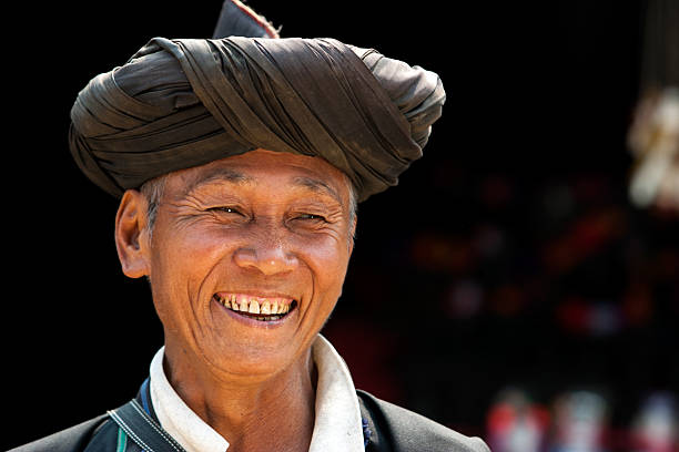 Lahu Hill Tribe Man "Chiang Rai, Thailand - February 12, 2005: A Head + Shoulders Portrait Of A Lahu Hill Tribe Man Smiling Dressed In Traditional Tribal Clothing." thai traditional costume stock pictures, royalty-free photos & images
