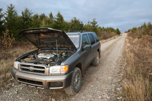 Antigonish County, Nova Scotia, Canada - October 29, 2007: A broken down Nissan Pathfinder on a remote stretch of road in the wilderness.