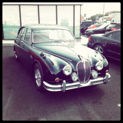 Halifax, Nova Scotia, Canada - September 4, 2012:  A 1960 Jaguar Mark II sits outside a showroom at a car dealership.  Other cars visible in background and beside Jaguar a Mercedes SL500 is visible.  It features a twin overhead cam, twin carbureted 3.8-liter engine that produced 220 horsepower.
