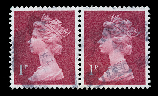 Varese, Italy, June 20, 2011: a picture of 2 identical UK postage stamps representing Queen Elizabeth in white on a red background.