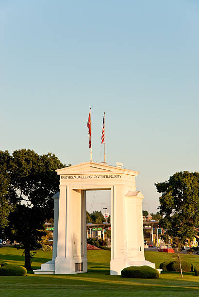 Peace Arch at Sunset Blaine, Washington, USA - July 11, 2012: The Peace Arch on the USA/Canada Border was built to dedicate 100 years of peace between the United States and Canada. The project was commissioned in the early 20th century by the wealthy railroad executive and entrepreneur Sam Hill who was also a Quaker pacifist. The Peace Arch, built in 1921, is located between Douglas, British Columbia, Canada and Blaine, Washington State, USA. jeff goulden border security stock pictures, royalty-free photos & images