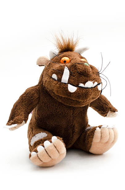 The Gruffalo "London, England, United Kingdom - August 25, 2013: The photo is showing a Gruffalo toy, a fictional character from a children's book. The photo was taken in a studio setting in front of a white background." creepy doll stock pictures, royalty-free photos & images